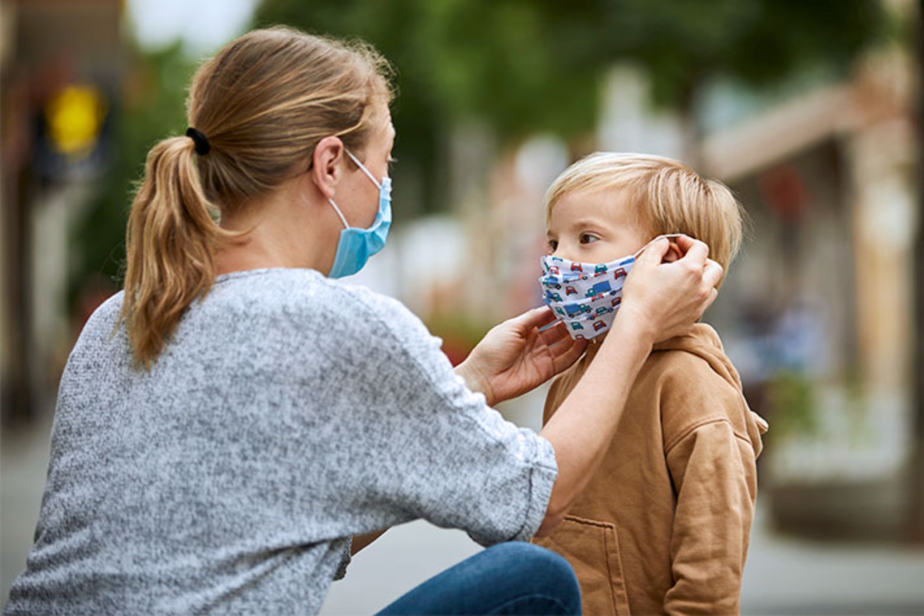 parent putting mask on child tripledemic abbott