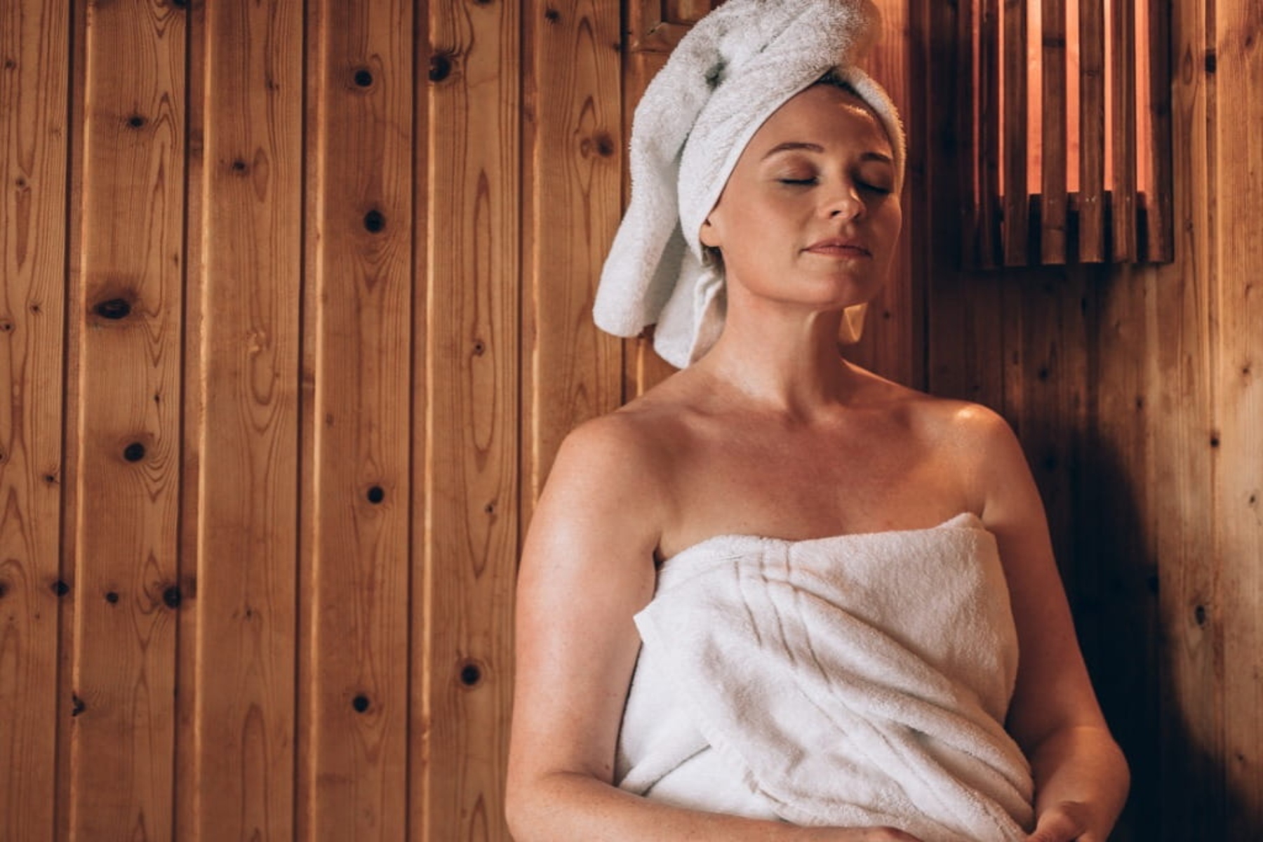 woman sitting in sauna