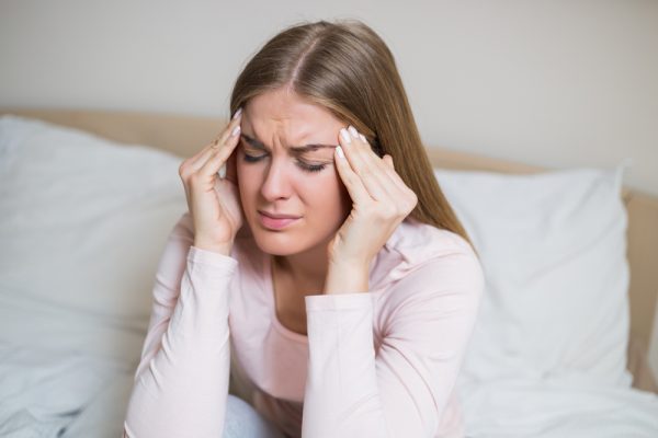 woman with headache e1678954699164