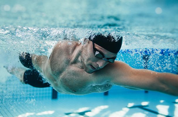 man swimming in pool e1658654692707