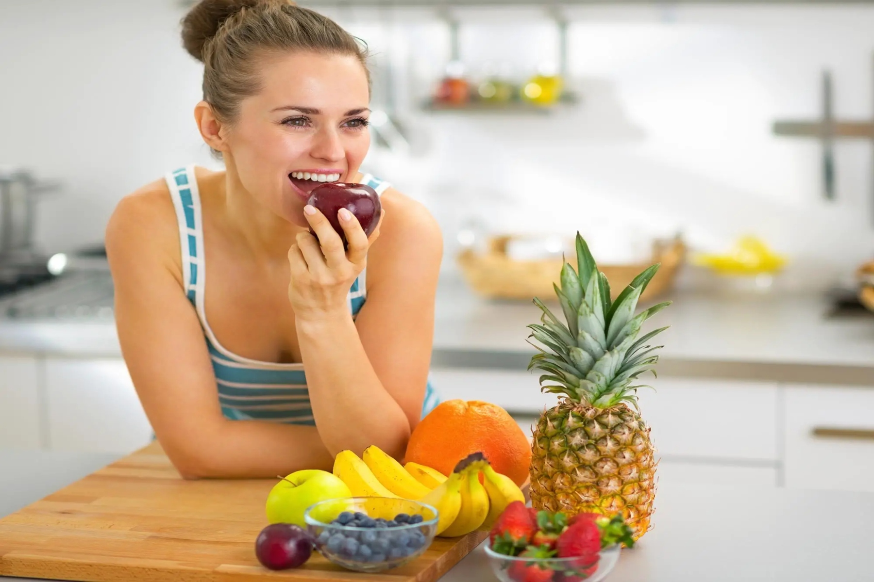 happy woman eating apple